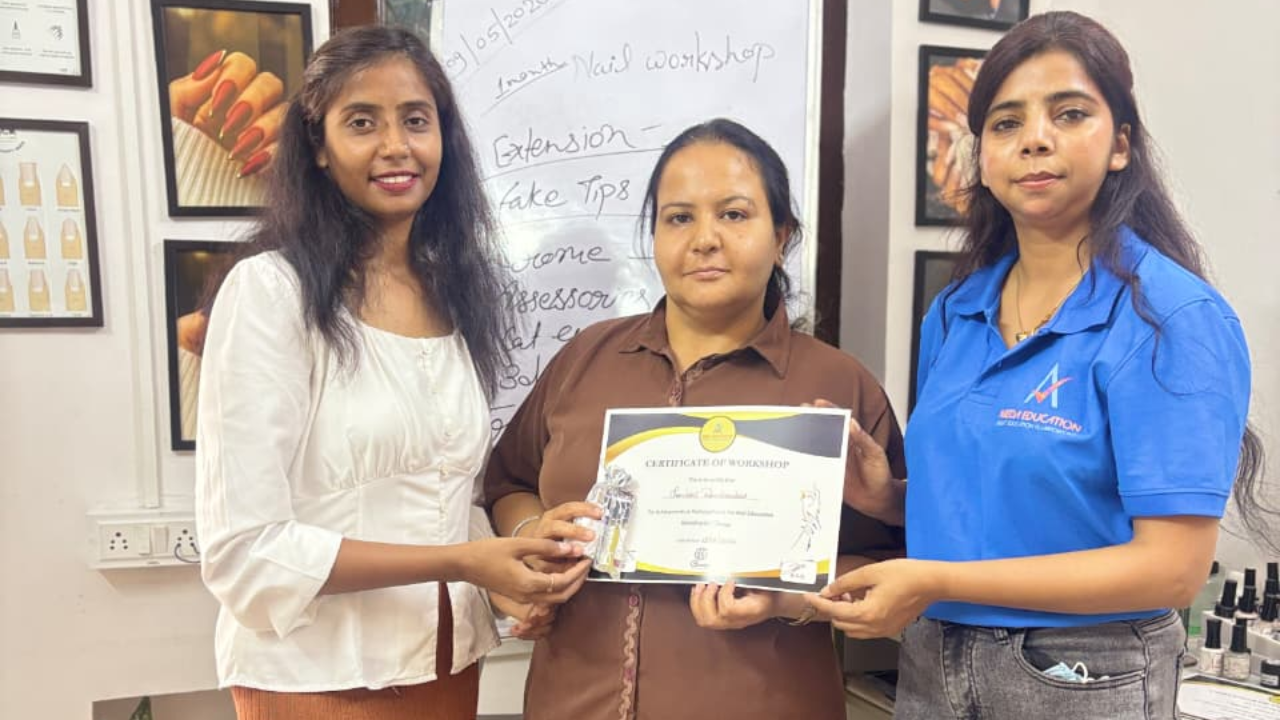 Student receiving her AVEDA Education workshop certificate